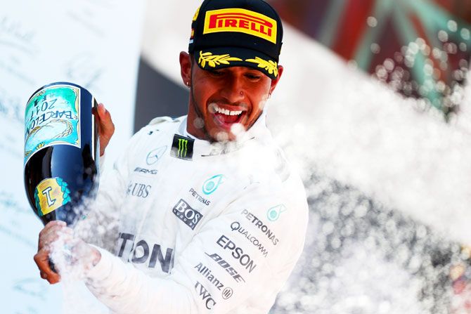 Lewis Hamilton of Great Britain and Mercedes GP celebrates on the podium after winning the Spanish Formula One Grand Prix at Circuit de Catalunya in Montmelo, Spain, on Sunday