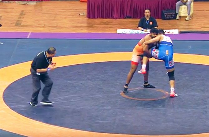 India's Sumit in action against Iran's Yadollah Mohammadkazem Mohebi