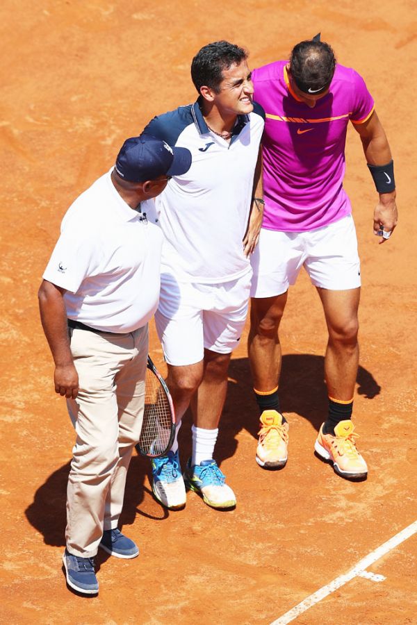 Spain's Nicolas Almagro (centre) is helped off court by Rafael Nadal (right) and umpire Carlos Bernardes (left) after retiring at 0-3 in the opening set on Day Four of The Internazionali BNL d'Italia 2017 at the Foro Italico in Rome, Italy, on Wednesday