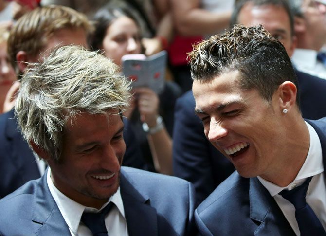 Real Madrid's Cristiano Ronaldo and teammate Fabio Coentrao attend a ceremony at the headquarters of Madrid's regional government, the Autonomous Community of Madrid on Monday