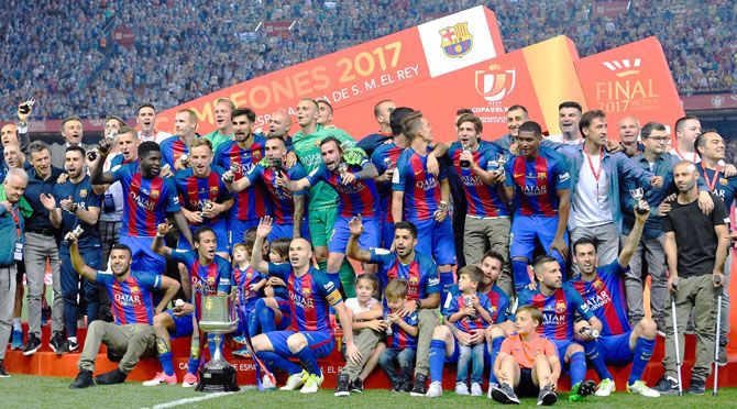 FC Barcelona players celebrate with the trophy after winning the Copa del Rey Final