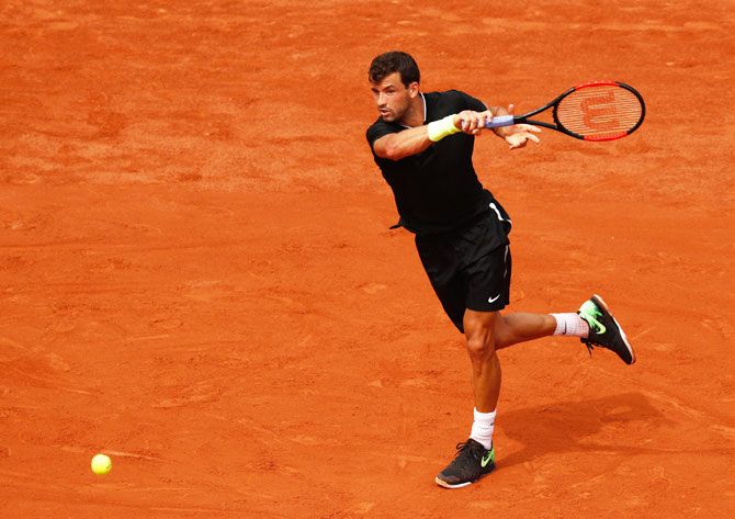 Bulgaria's Grigor Dimitrov plays a forehand return during his first round match against France's Stephane Robert