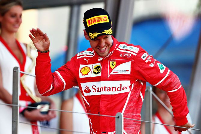 Sebastian Vettel of Germany and Ferrari celebrates on the podium after his win at the Monaco Formula One Grand Prix at Circuit de Monaco in Monte-Carlo, Monaco, on Sunday