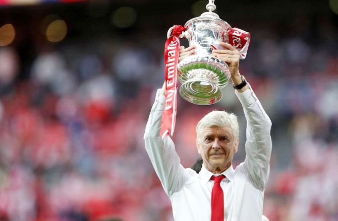 Arsene Wenger celebrates with the trophy after Arsenal's FA Cup win over Chelsea on Saturday