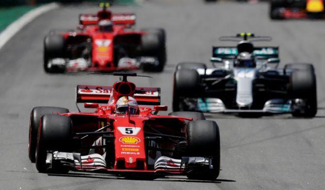 Ferrari's Sebastian Vettel leads Mercedes' Valtteri Bottas and Ferrari's Kimi Raikkonen during the Brazilian F1 GP race in Sao Paulo, Brazil on Sunday