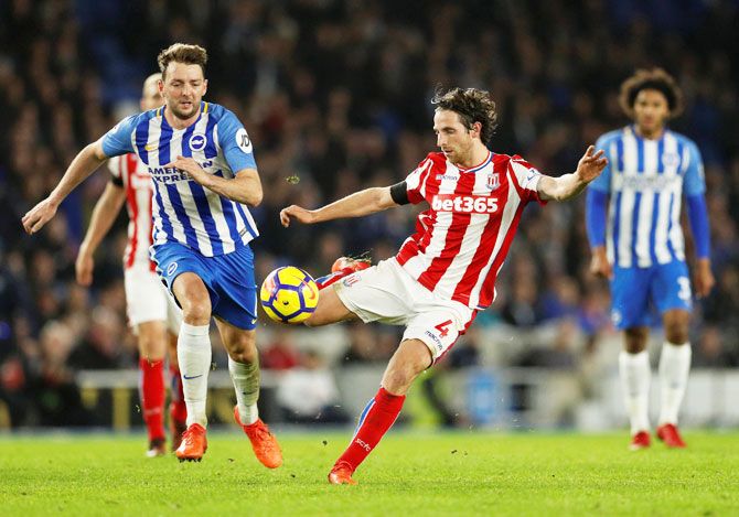 Stoke City's Joe Allen in action and Brighton's Dale Stephens in action during their English Premier League match at The American Express Community Stadium, in Brighton on Monday