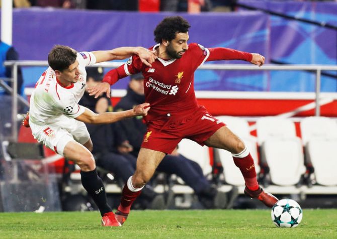 Liverpool's Mohamed Salah is challenged by Sevilla’s Clement Lenglet