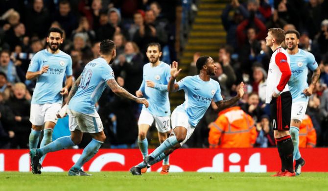Manchester City's Raheem Sterling celebrates scoring their first goal with teammates