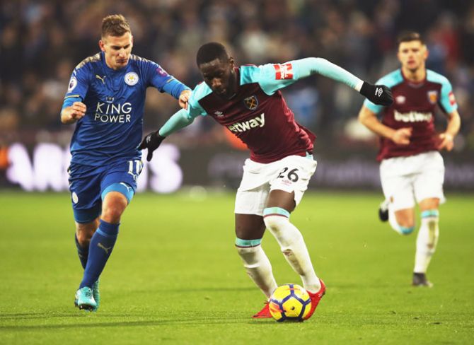 West Ham United's Arthur Masuaku holds off Leicester City's Marc Albrighton during their English Premier League match at London Stadium in London on Friday