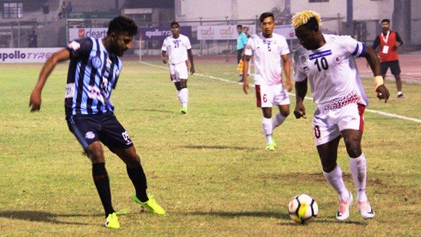 Players from Minerva Punjab and Mohun Bagan vie for possession