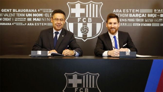Lionel Messi with FC Barclona president Josep Maria Bartomeu as he signs the contract extension deal on Saturday