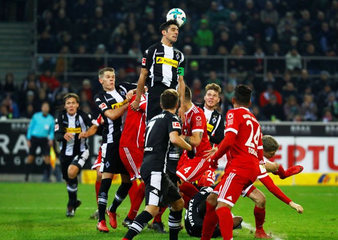 Borussia Monchengladbach’s Lars Stindl and Bayern players vie for possession