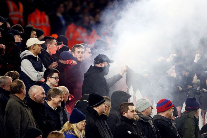 A flare is set off during the Premier League match between Brighton and Hove Albion and Crystal Palace at Amex Stadium on Tuesday