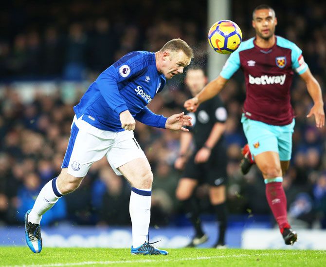 Everton's Wayne Rooney heads to score the opening goal against West Ham United at Goodison Park in Liverpool