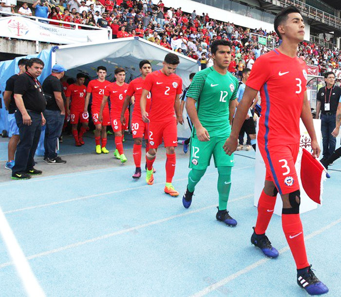Chile goalkeeper Julio Borquez (2nd from right) walks out of the dugout with teammates