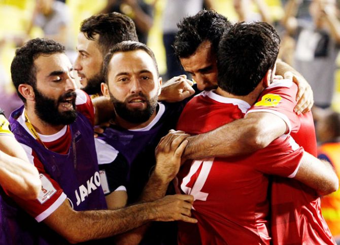Syria's Omar Al Soma celebrates after scoring during their 2018 World Cup Qualifying Asia Zone Playoffs against Australia in Hang Jebat Stadium, Melaka, Malaysia