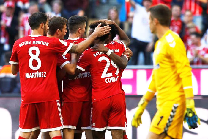 Bayern Munich players celebrate after Thomas Mueller scores against Freiburg on Saturday