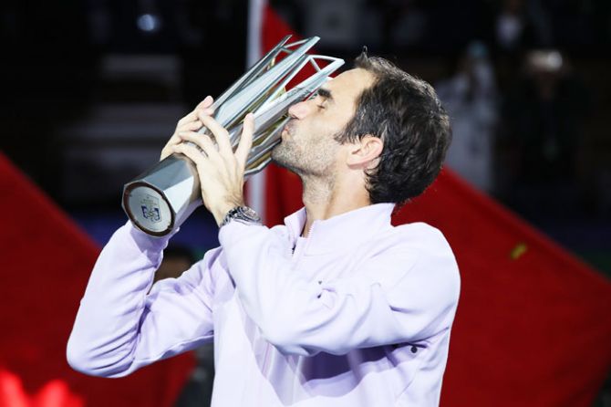 Roger Federer kisses the trophy after winning the Shanghai Open title on Sunday