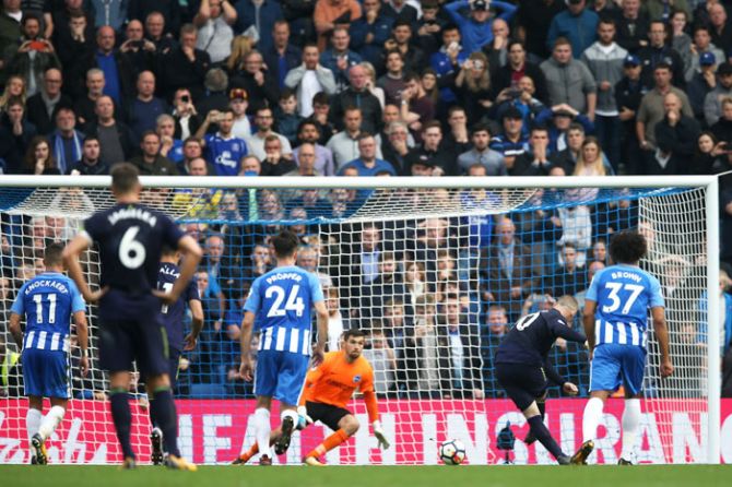 Everton's Wayne Rooney scores from the penalty spot during their Premier League match against Brighton and Hove Albion at Amex Stadium in Brighton, England, on Sunday