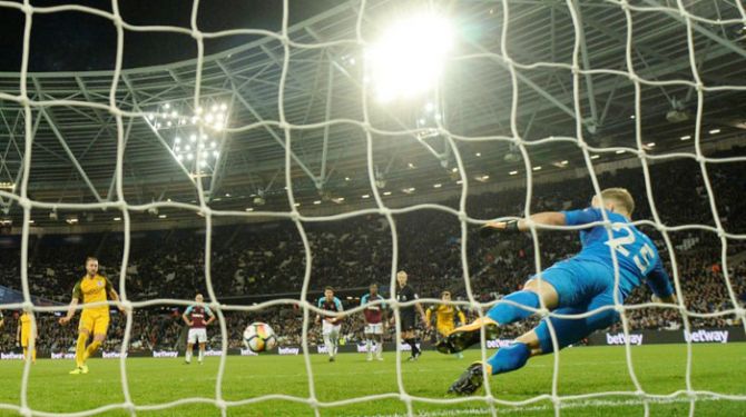 Brighton's Glenn Murray scores their third goal from the penalty spot during their English Premier League match against West Ham United at London Stadium on Friday