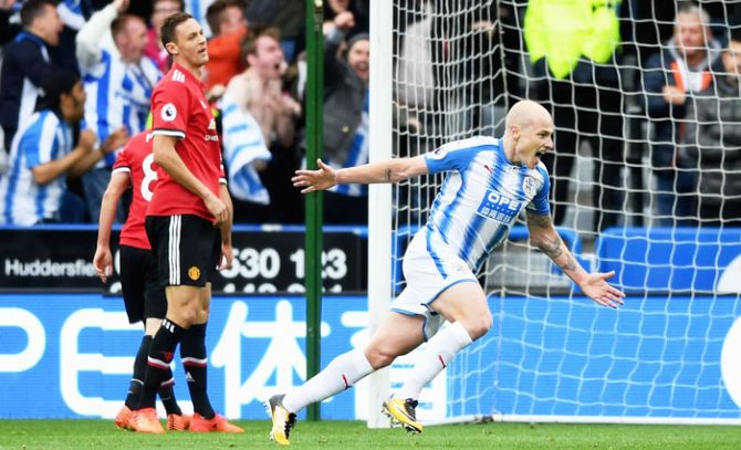 Huddersfield Town's Aaron Mooy celebrates as he scores the opening goal against Manchester United during their English Premier League match at John Smith's Stadium in Huddersfield, England, on Saturday