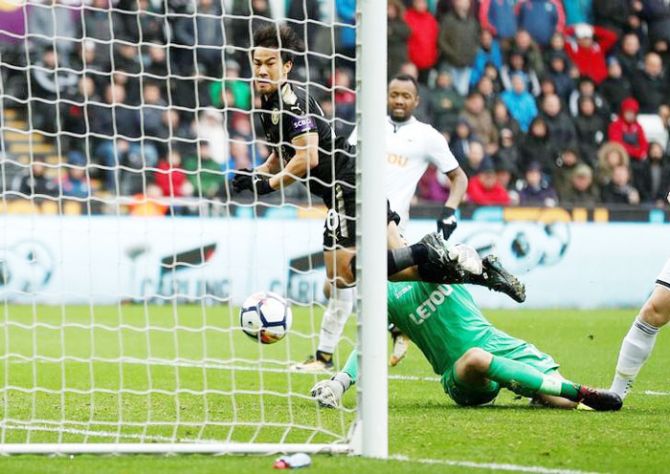 Leicester City's Shinji Okazaki scores their second goal against Swansea City during their English Premier League match at Liberty Stadium in Swansea on Saturday