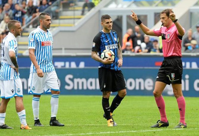 Referee Claudio Gavillucci awards a penalty to Inter Milan after a video review as Mauro Icardi prepares to take the kick during the Serie A match between Inter and SPAL in Milan on Sunday