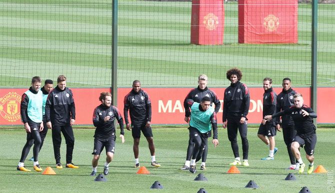 Manchester United players perform drills at a training session at Carrington on Monday