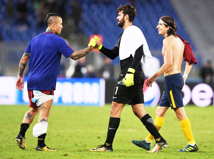 AS Roma's Radja Nainggolan congratulates 'keeper Alisson Becker as he walks off the pitch alongside Atletico Madrid's Filipe Luis at the end of the UEFA Champions League match at Stadio Olimpico, Rome, on Tuesday