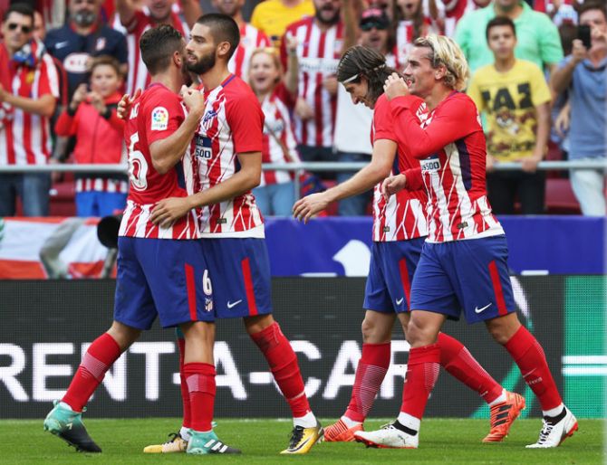 Atletico Madrid’s Antoine Griezmann celebrates with teammates after scoring their second goal against Sevilla at Wanda Metropolitano, Madrid on Saturday