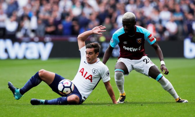 Tottenham's Harry Winks and West Ham United's Arthur Masuaku vie for possession