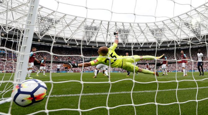 Tottenham's Christian Eriksen scores their third goal against West Ham during their English Premier League match in London on Saturday