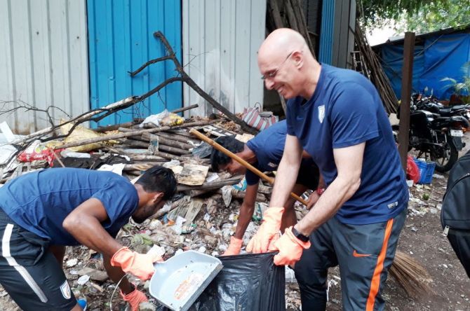 Indian football coach Stephen Constantine and members of the Indian football team get down to work as they participate in the 'Swachhta Hi Seva campaign