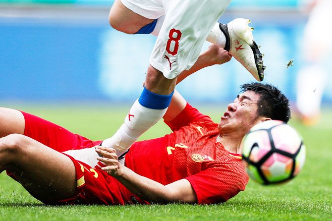 China's Liu Yiming and the Czech Republic's Vladimir Darida in action during the China Cup on March 26