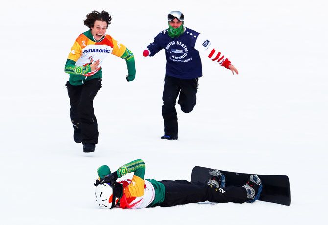 Australia's Simon Patmore lies in the snow after winning the event as fellow competitor Ben Tudhope rushes to congratulate him during the men's snowboard cross SB-UL big final at Jeongseon Alpine Centre in Jeongseon, South Korea at the Pyeongchang 2018 Winter Paralympics on March 12