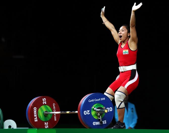 Mirabai Chanu celebrates after winning gold in the women's weightlifting 48kg category