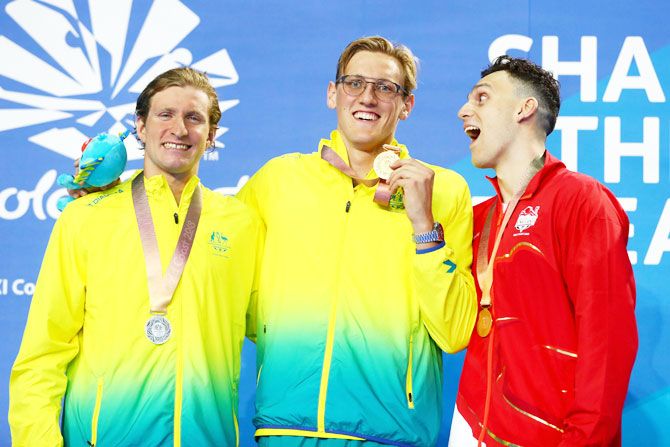 (L-R) Silver medalist Jack McLoughlin of Australia, gold medalist Mack Horton of Australia and bronze medalist James Guy of England clown about on the podium during the medal ceremony for the Men's 400m freestyle final on Day 1 of the Gold Coast 2018 Commonwealth Games at Optus Aquatic Centre on the Gold Coast, Australia, on Thursday