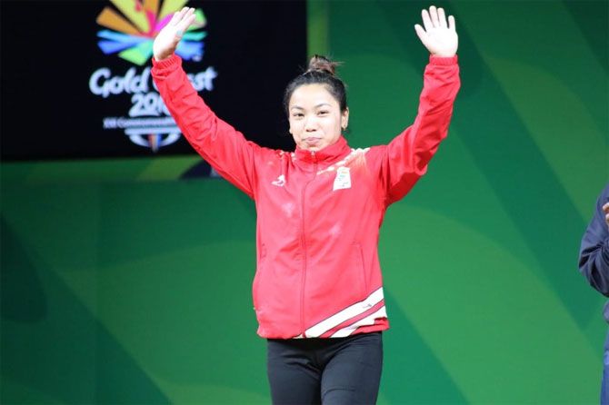 Mirabai Chanu steps up on the podium to receive her gold medal