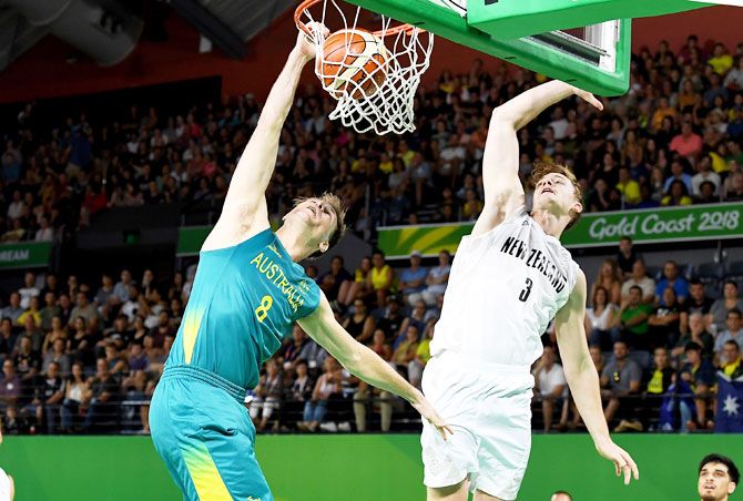 Australia's Brad Newley slam dunks during the preliminary basketball round match against New Zealand at Cairns Convention Centre in Cairns