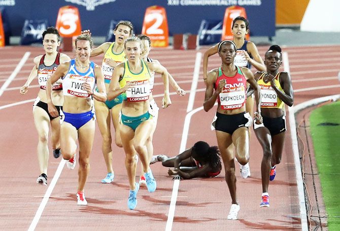 Kenya's Winny Chebet falls in the Women's 1500 metres heats at Carrara Stadium on Monday
