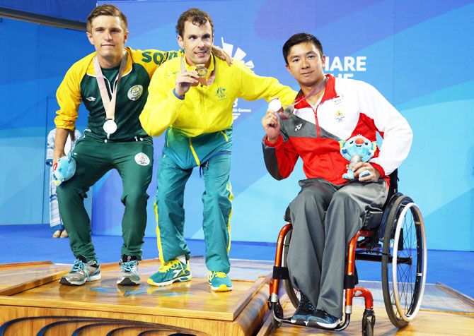 Gold medalist Matthew Levy of Australia, silver medalist Christian Sadie of South Africa and bronze medalist Toh Wei Soong of Singapore on the podium after the Men's S7 50m Freestyle swimming at the Optus Aquatic Centre on Monday