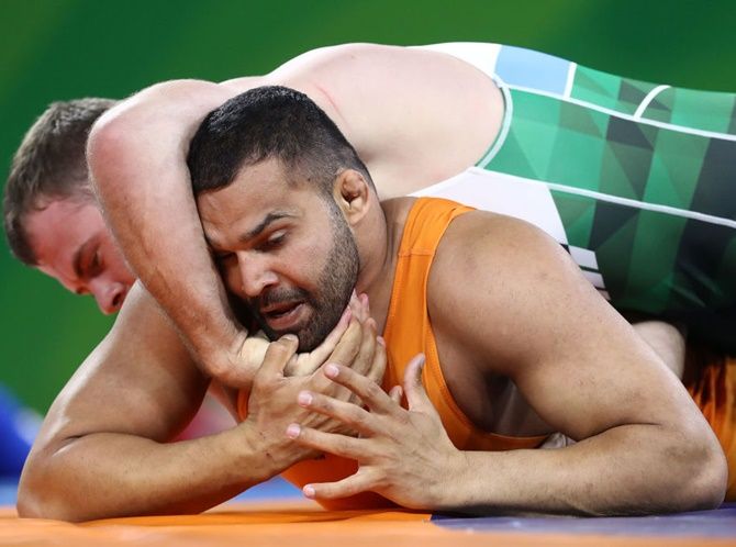 India's Mausam Khatri competes against Martin Erasmus of South Africa in the men's freestyle 97 kg