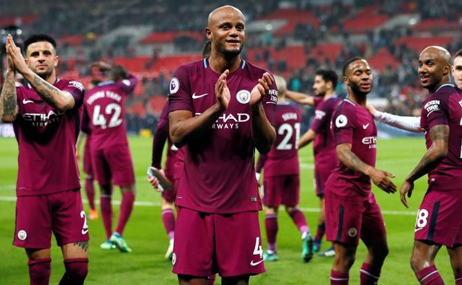 Manchester City's Vincent Kompany and his team-mates applaud the fans after a match