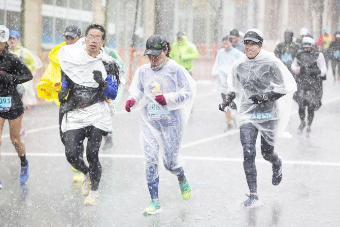 Runners approach the 24 mile marker of the 2018 Boston Marathon in heavy rain