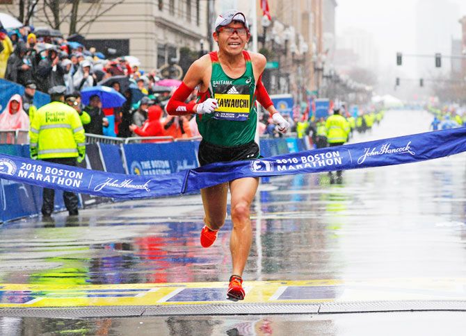 Japan's Yuki Kawauchi crosses the finish line to win the men's division of the 122nd Boston Marathon