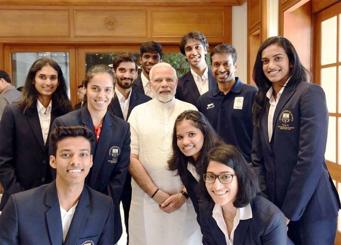 Prime Minister Narendra Modi (centre) with India's CWG badminton medal winners, including coach P Gopichand