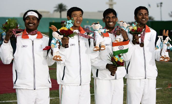 (From left to right) India's Mangal Singh Champia, Tarundeep Rai, Jayanta Talukda and Viswash with their bronze medals during the ceremony after the Men's team Archery event at the 2006 Asian Games in Doha at the Lusail Archery Range on in Doha, Qatar