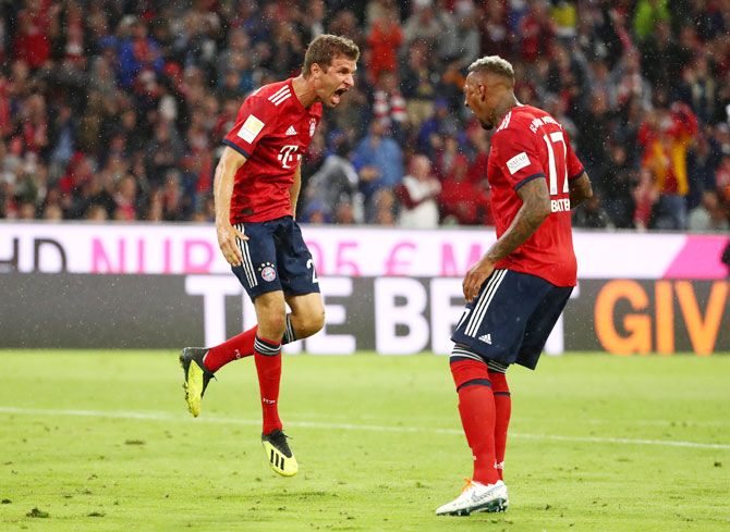 Bayern Munich's Thomas Mueller celebrates scoring their first goal with Jerome Boateng 