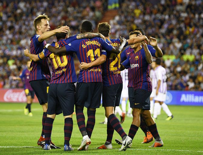 Barcelona players celebrate after Ousmane Dembele scores the first goal against Real Valladolid CF during their La Liga match at Jose Zorrilla in Valladolid, Spain, on Sunday