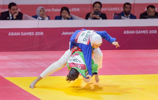 Indian Kurash player Binisha Biju Nayakattu (green) competes with Iran's Azar Koolivand in the women's 63kg (R32) Kurash at the 18th Asian Games Jakarta-Palembang 2018, in Jakarta, Indonesia on Wednesday